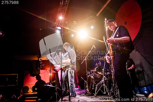 Image of Band performs on stage in a nightclub