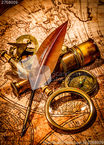 Image of Vintage magnifying glass lies on an ancient world map