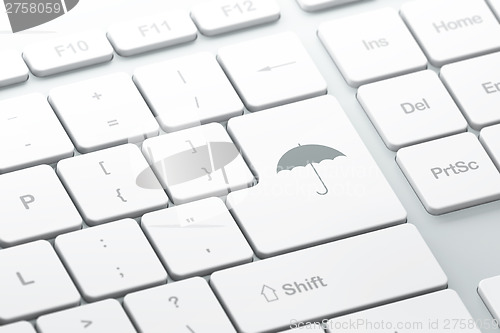Image of Protection concept: Umbrella on computer keyboard background