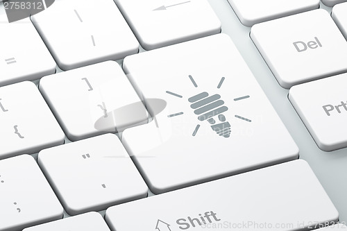 Image of Business concept: Energy Saving Lamp on computer keyboard backgr