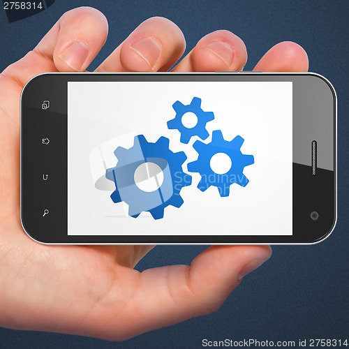 Image of Business concept: Gears on smartphone