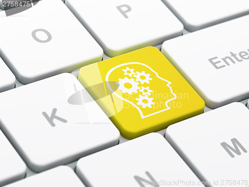 Image of Advertising concept: Head With Gears on computer keyboard backgr