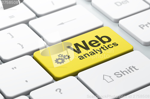 Image of Web design concept: Gears and Web Analytics on computer keyboard