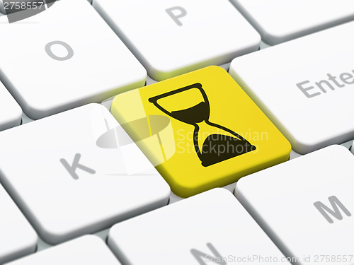 Image of Time concept: Hourglass on computer keyboard background