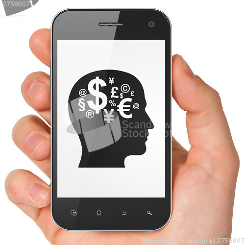 Image of Finance concept: Head With Finance Symbol on smartphone