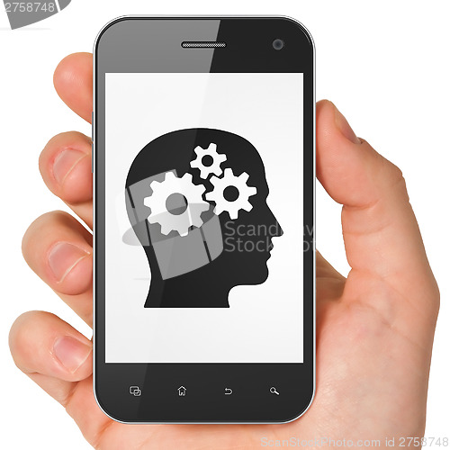 Image of Marketing concept: Head With Gears on smartphone