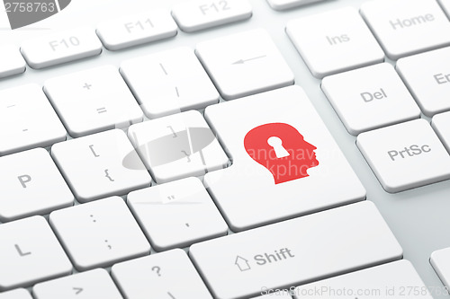Image of Security concept: Head With Keyhole on computer keyboard backgro