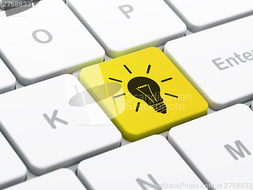 Image of Finance concept: Light Bulb on computer keyboard background