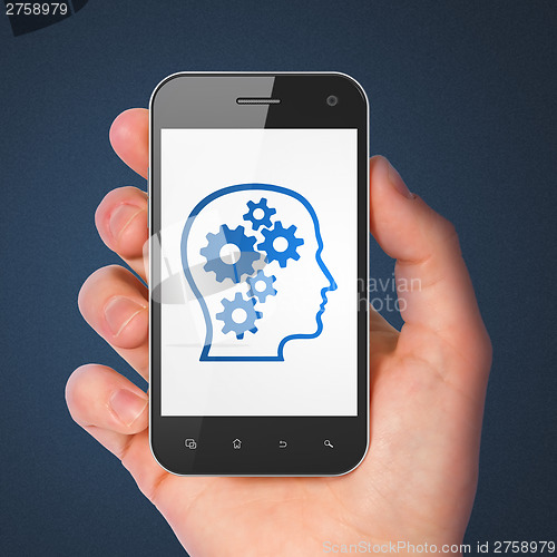 Image of Advertising concept: Head With Gears on smartphone