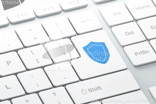 Image of Protection concept: Shield on computer keyboard background