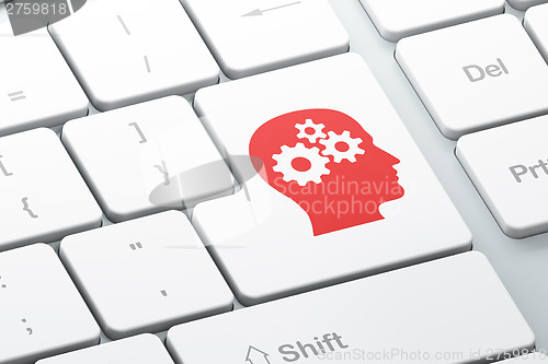 Image of Information concept: Head With Gears on computer keyboard backgr
