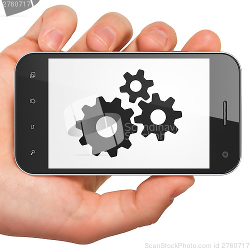 Image of Information concept: Gears on smartphone