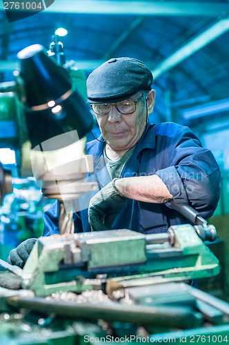 Image of The milling-machine operator works at the machine