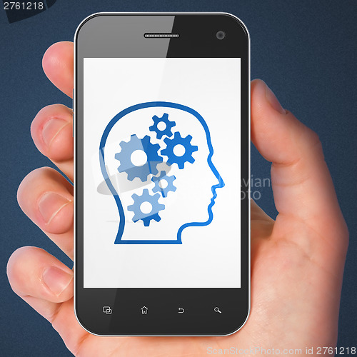 Image of Marketing concept: Head With Gears on smartphone