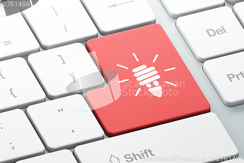 Image of Finance concept: computer keyboard with Energy Saving Lamp
