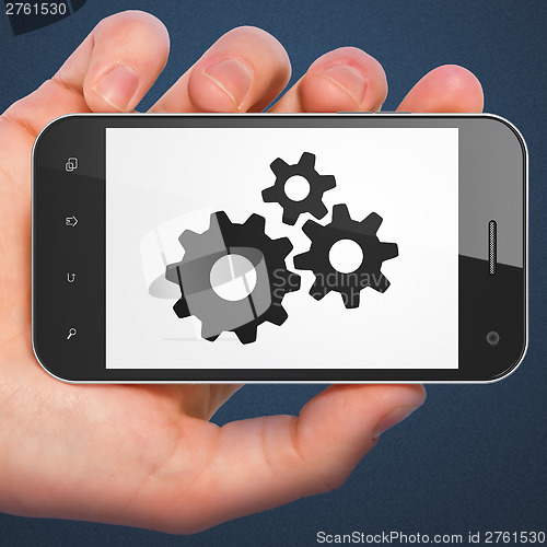 Image of Advertising concept: smartphone with Gears.