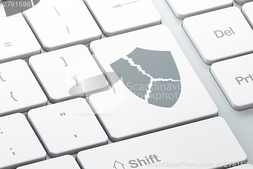 Image of Privacy concept: computer keyboard with Broken Shield