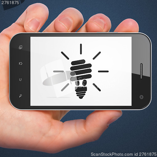 Image of Finance concept: smartphone with Energy Saving Lamp.