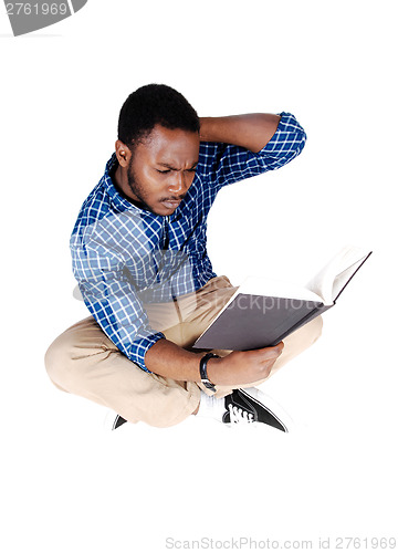 Image of Black man sitting on floor.