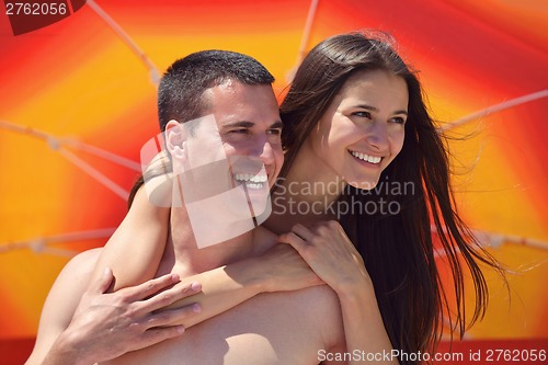 Image of happy couple have fun on the beach