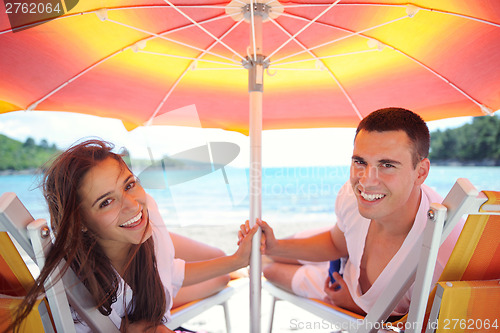 Image of happy couple have fun on the beach