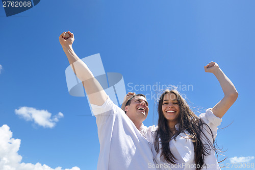 Image of happy couple have fun on the beach