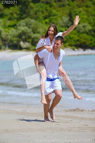 Image of happy couple have fun on the beach