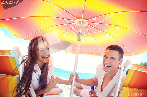 Image of happy couple have fun on the beach