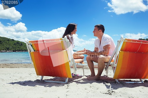 Image of happy couple have fun on the beach