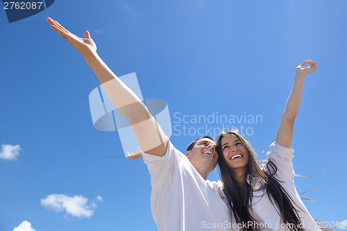 Image of happy couple have fun on the beach