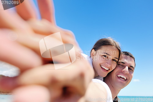 Image of happy couple have fun on the beach