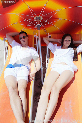 Image of happy couple have fun on the beach