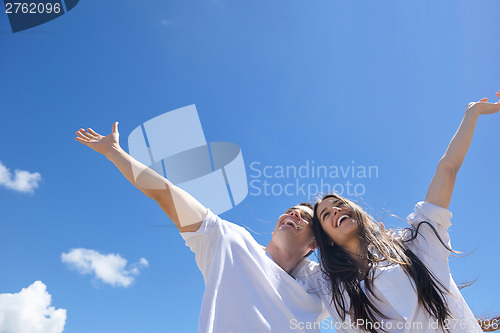 Image of happy couple have fun on the beach