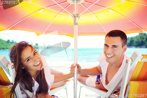 Image of happy couple have fun on the beach