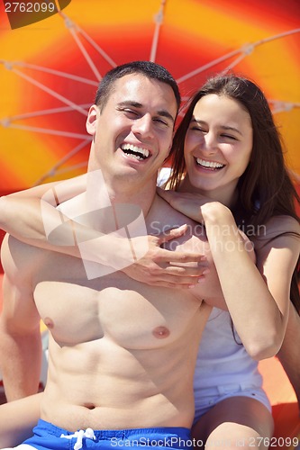 Image of happy couple have fun on the beach