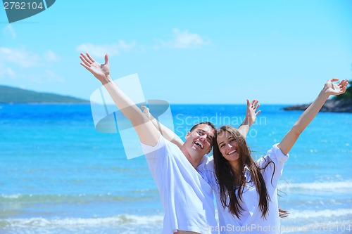 Image of happy couple have fun on the beach