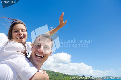 Image of happy couple have fun on the beach