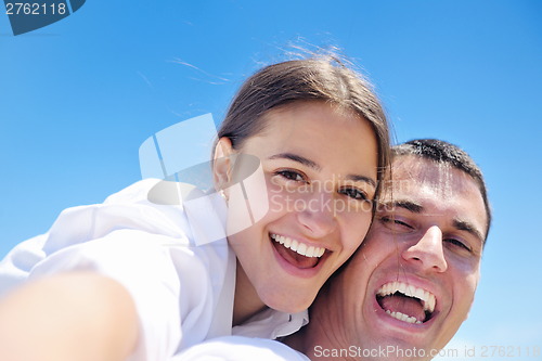 Image of happy couple have fun on the beach