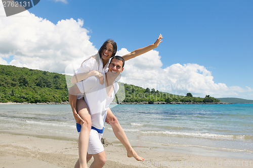 Image of happy couple have fun on the beach