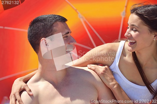 Image of happy couple have fun on the beach