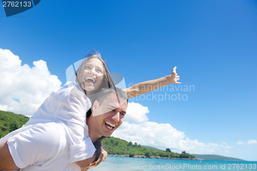 Image of happy couple have fun on the beach