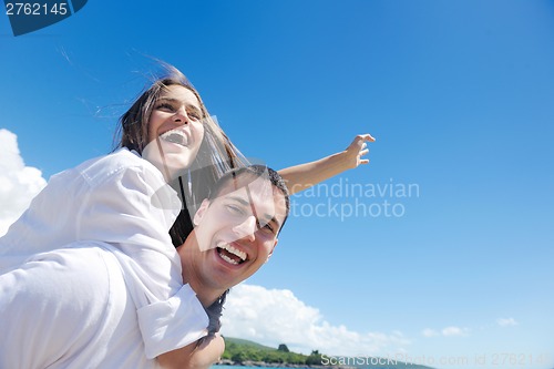 Image of happy couple have fun on the beach