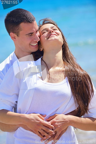 Image of happy couple have fun on the beach
