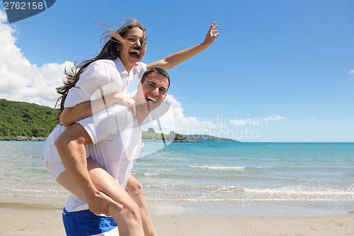 Image of happy couple have fun on the beach