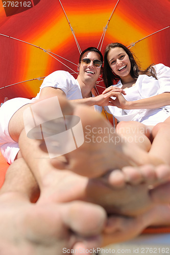 Image of happy couple have fun on the beach