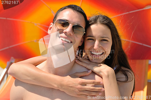 Image of happy couple have fun on the beach