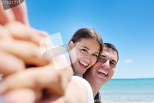 Image of happy couple have fun on the beach