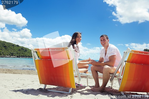 Image of happy couple have fun on the beach
