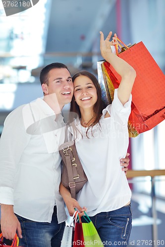 Image of happy young couple in shopping