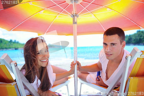 Image of happy couple have fun on the beach